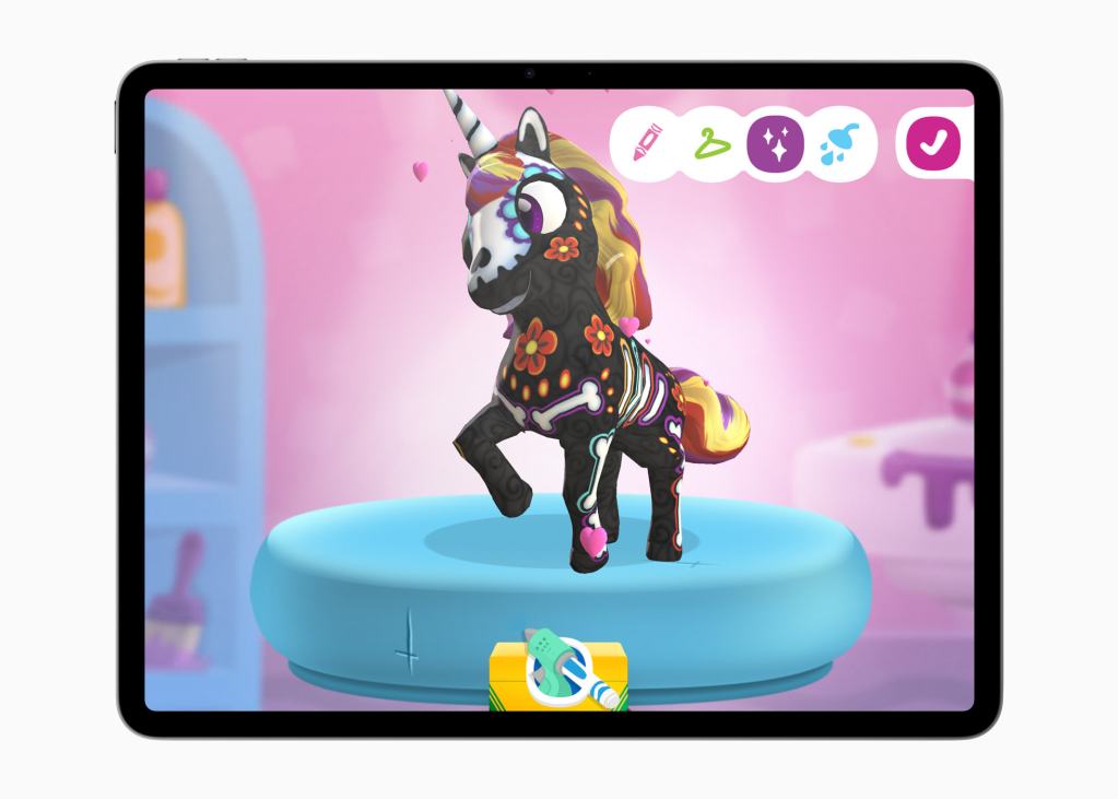 A colorful digital unicorn figure displayed on a tablet, showcasing creative design options.