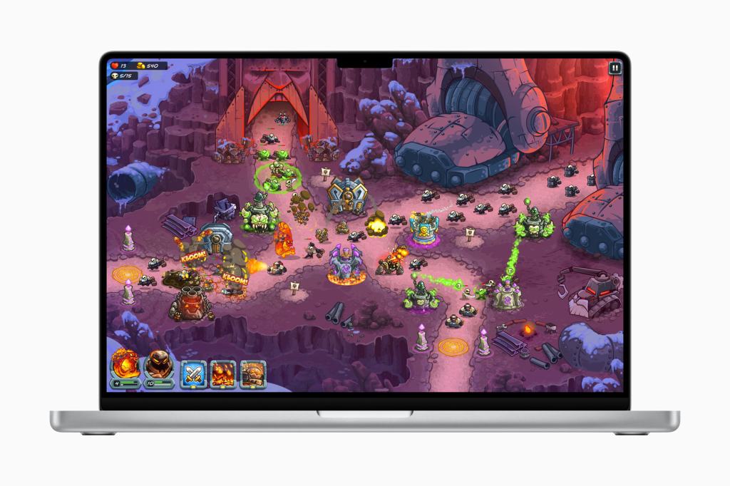 A scene from the Kingdom Rush 5: Alliance TD+ game displayed on a laptop screen, featuring a vibrant battlefield with various defense towers, enemies, and strategic elements.