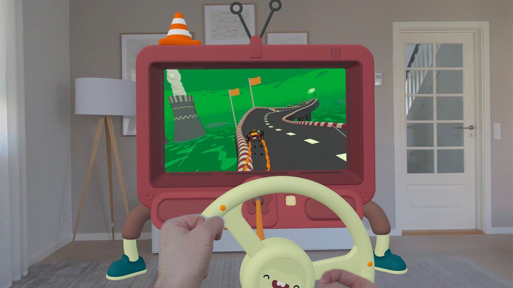 A person playing a racing game using a cartoonish steering wheel controller in front of a colorful screen resembling a television, set in a modern living room.