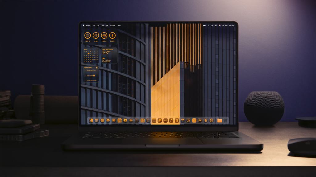 새로운 macOS Tahoe 26 인터페이스가 적용된 노트북 화면, 어두운 배경에 주황색과 회색 톤의 디자인이 강조되어 있으며, 여러 애플리케이션과 위젯이 표시된 모습.