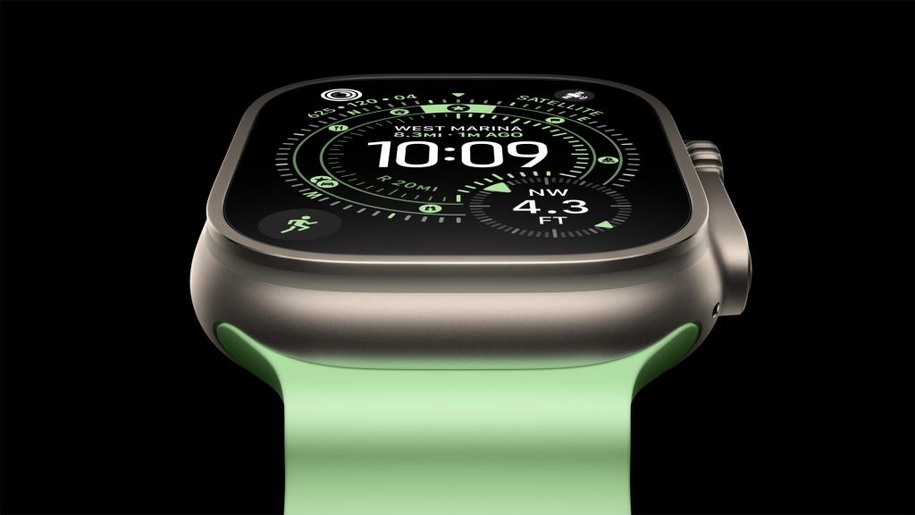 Apple Watch Ultra 3의 디스플레이와 그린 컬러의 밴드가 있는 모습, 시계 페이스에 GPS 및 다른 정보가 표시되어 있음.