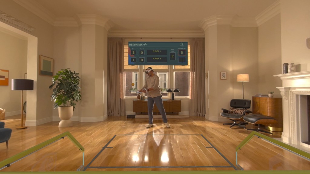 A person interacting with a virtual interface in a cozy living room, featuring a scoreboard displayed on a wall. The room has wooden flooring, a large window with curtains, and furniture including a plant and a lamp.