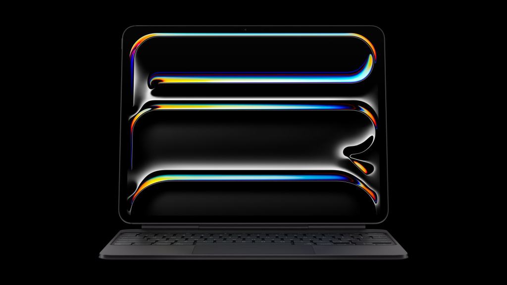 Apple, M5 칩을 탑재한 혁신적인 iPad Pro 발표 13 아이패드 프로의 전면과 키보드가 있는 모습, 화면은 어두운 배경에서 다양한 색상의 그래픽이 나타나 있다.