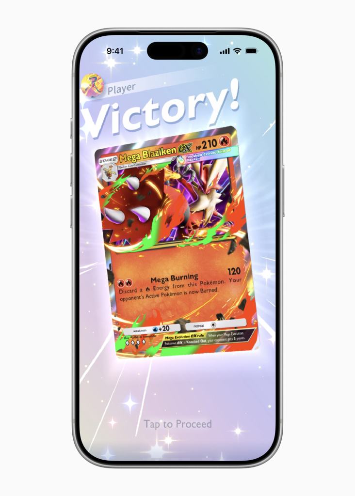 A smartphone displaying a Pokémon trading card with the text 'Victory!' prominently at the top, celebrating a win in the game. The card features Mega Blaziken ex, showcasing its stats and abilities against a sparkly background.